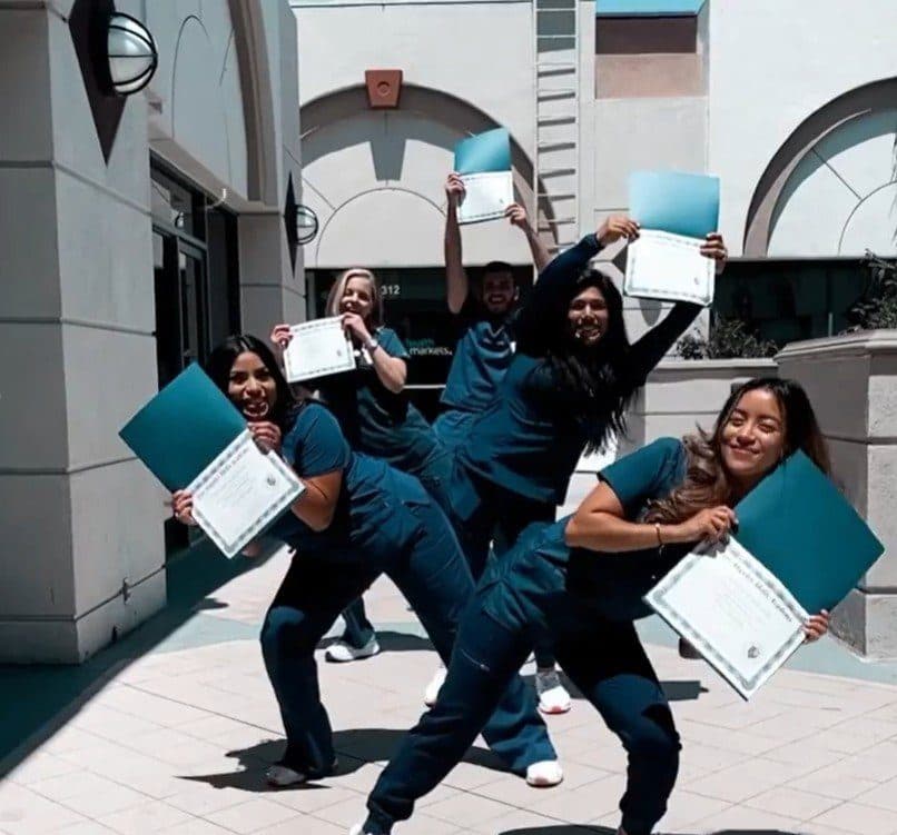Graduates celebrating with their certificates