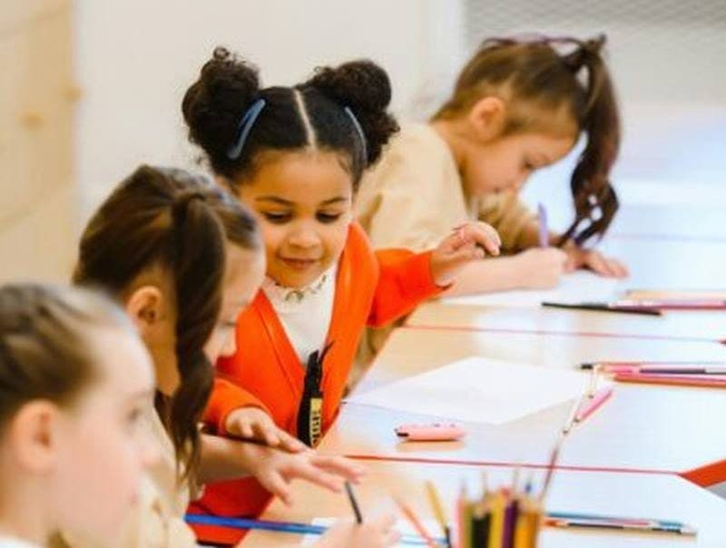 Young students drawing together in a classroom