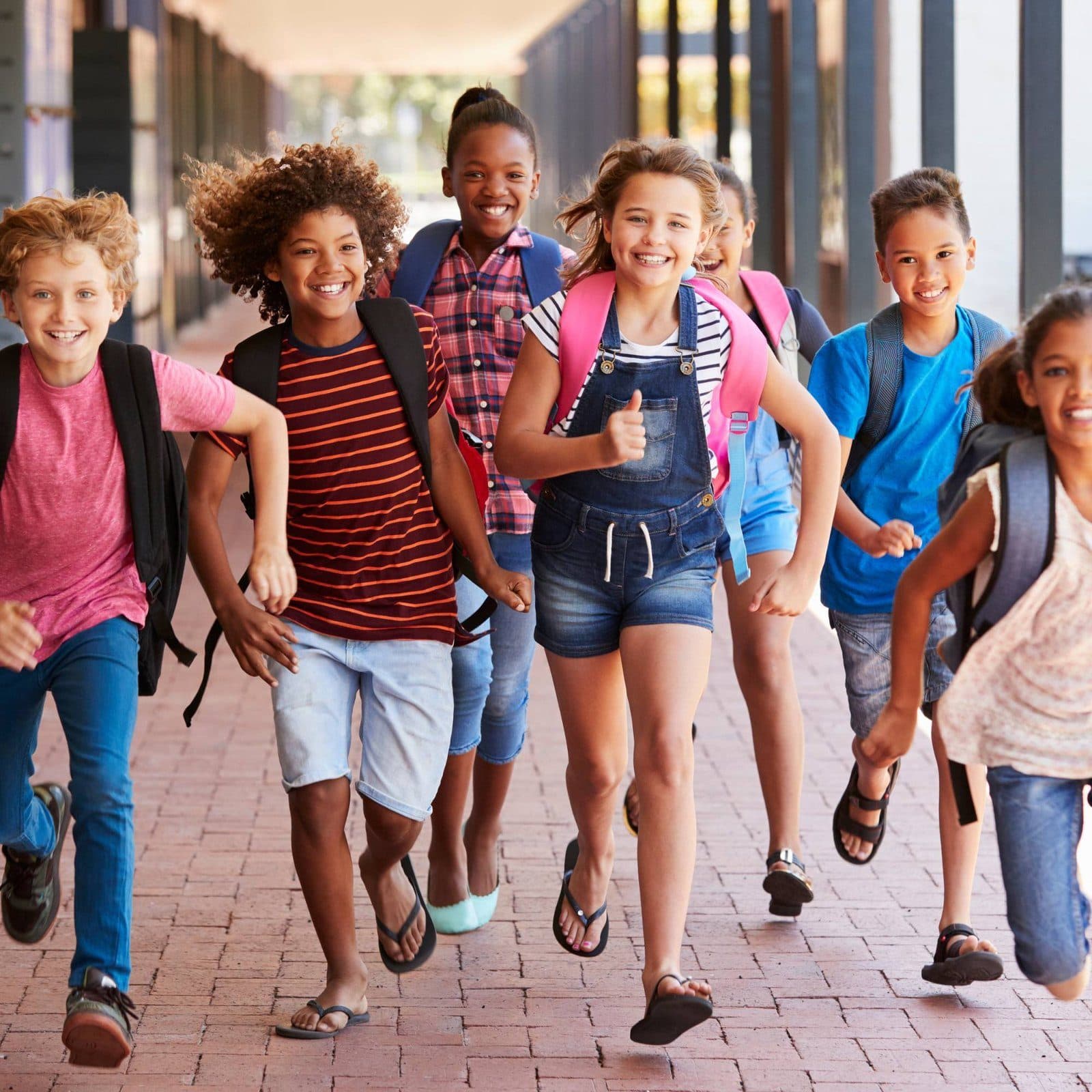 Students running down a school hallway